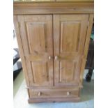 Small waxed pine wardrobe, panel doors with fitted interior above a drawer, W98cm D58cm H148cm