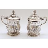 Victorian pair of hallmarked silver condiment pots with scrolled handles, hinged lids and baluster