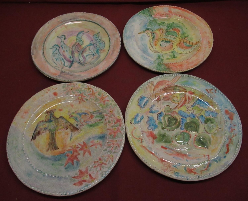 Set of four C20th glazed terracotta circular plaques or dinner plates polychrome decoration