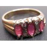 9ct yellow gold ring set with three oval cut rubies and four brilliant cut diamonds, stamped 375,