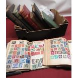 Five mid C20th stamp albums containing a collection of used stamps, loose stamps and various novels