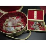 Vintage jewellery box containing costume jewellery including a shell necklace, an enamel shield