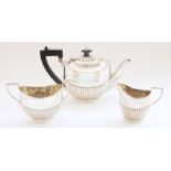 Ed.VII hallmarked silver three piece tea service of fluted shape with ebony handle and finial to the