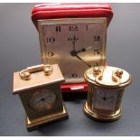 Swiza 8 day travel alarm clock in red leather clam shell case, running, and two miniature brass