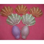 Two green clam shell design wall shades, three amber glass clam shell design wall light shades and