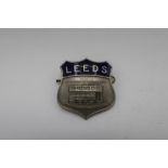 White metal and blue enamel Leeds Tram shield shaped cap badge, by Firmin London