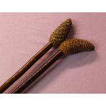 2 walking sticks both cherry shanks and pinecone tops. Overall length 135cm.