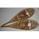 Pair of wooden snow shoes with leather boot strapping. Made by Faber, Loretteville, Quebec,