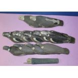 Twelve pigeon decoys of aluminium, fibre glass, plastic, and canvas materials, with pegs (12)