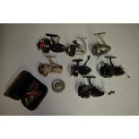 Collection of seven vintage spinning reels including J.W. Young & Sons Ambidex casting reel,