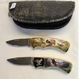 Pair of Franklin Mint pocket knives with ornate engraving and pictures, one of wild turkeys, other