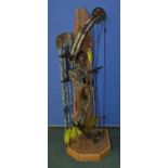 A Reflex Timberwolf archery compound bow with 6 arrows (1 without pointed tip) and a scenic stand