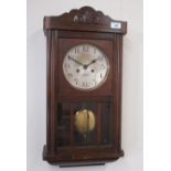 Inter-war continental oak cased wall clock, glazed panelled door opening to brass bezel and silvered