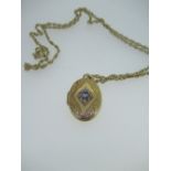 9ct yellow gold locket set with pale blue stone and illusion set diamonds, stamped 375, on a 9ct