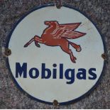 A circular enameled steel plate advertising sign for Mobilgas. Diameter 37.5cm