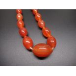 Amber type necklace, single row of oval graduated beads, largest approx L2.5cm, with screw