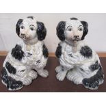 Large pair of black and white Staffordshire style dogs with yellow painted collars and chains, H30cm