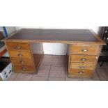 C20th oak twin pedestal desk with inset top and eight drawers, W170cm D80cm H77cm