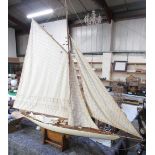 Nauticalia London, painted and natural wood finish model of a J-Class racing yacht on stand,