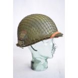 A US Army M1 Mk2 rear seam steel helmet, with liner, chin straps etc. Repainted/sprayed over with