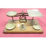 C20th lacquered brass postage scales, on oak base with weights, W26cm D15cm H10cm