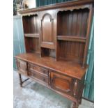 C20th oak dresser, shelved panel back above two drawers and two doors, on bobbin turned legs with