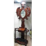 Victorian mahogany hallstand, shaped back with oval mirror and eight coat pegs above a drawer,
