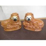 Pair of Staffordshire type models of recumbant lions, with inset eyes, W28cm H25cm (2)