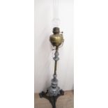C20th wrought iron and brass floor standing rise and fall oil lamp with barley twist column, over
