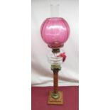 Late C19th oil lamp, cranberry coloured shade, faceted clear glass reservoir on sienna marble