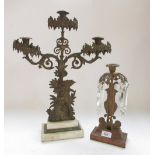 Regency style gilt metal urn shaped candlestick, hung with prismatic lustres, bronze base stamped