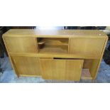 1950s early G-plan light oak lounge unit with central recess and sliding cupboard doors above two