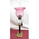Late C19th oil lamp with etched cranberry tinted shade, spherical faceted clear glass reservoir on