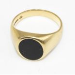 18ct yellow gold signet ring, the oval face set with a black stone, stamped 750, size R, 10.8g