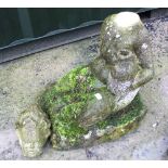 The Grange Goathland - Statue of a reclining cherub seated on a stone plinth holding a large fish