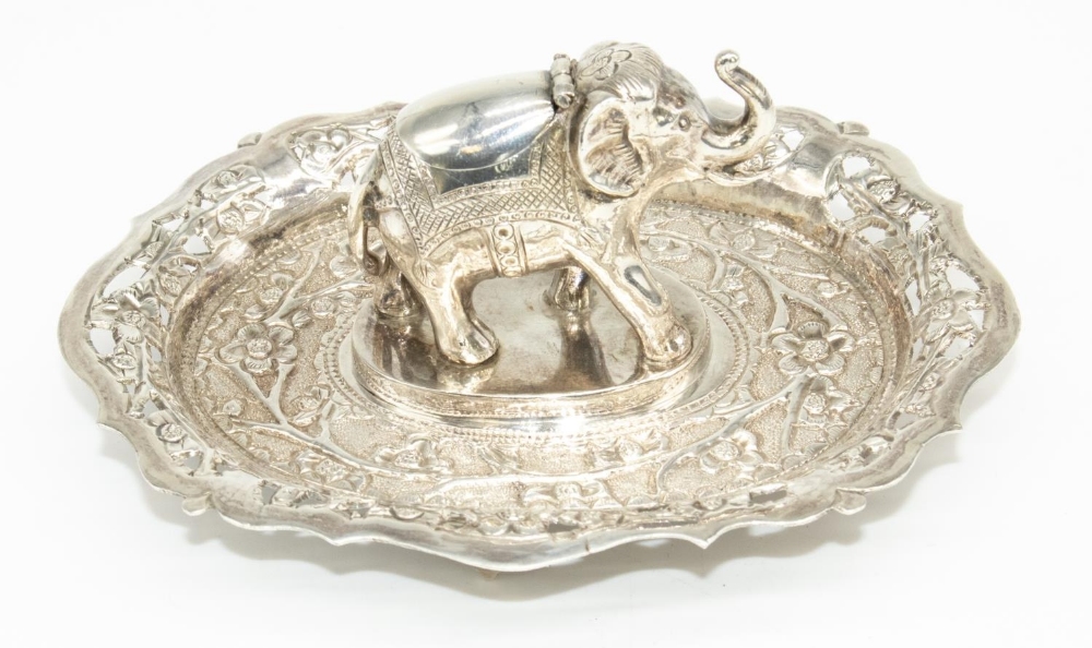 C20th Indian white metal match strike in the form of an elephant, oval base relief and pierced