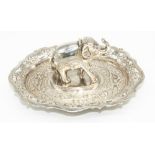 C20th Indian white metal match strike in the form of an elephant, oval base relief and pierced