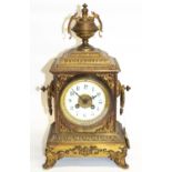 Late C19th cast gilt metal mantel clock, stepped rectangular case with urn finial on four scroll