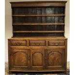 Geo. III oak dresser, three shelf back with moulded cornice above base, with three fielded panel