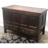 Geo.111 oak mule chest, hinged planked top above four fielded panels and two drawers, on stile feet,