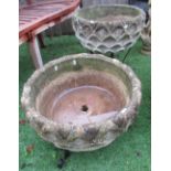 Pair of reconstituted stone circular planters with a wave style design, D50cm (3)