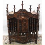 C19th French walnut spindle turned and carved Panetière, the scrolled pediment above an arched