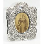 C20th Indian white metal rectangular easel photo. frame, pierced with floral scrollwork on C
