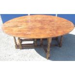 C17th style oak Wake table, oval top with two fall leaves on twin gate baluster turned and block