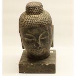 Eastern carved stone bust of Buddha, head and neck on square plinth, H36cm (2)