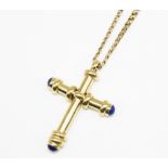 18ct yellow gold cross pendant set with blue stones, stamped 750, H5cm, on 18ct yellow gold chain,