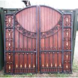 Pair of large cast iron and wooden courtyard gates with wood back with floral and spearhead