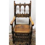 Charles II style oak arm chair, baluster and arcade carved back with scroll cresting, solid seat