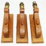 Robert Mouseman Thompson of Kilburn - a set of three oak wall lights, scrolled support on square