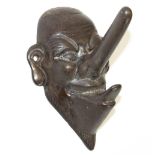 C20th novelty cast metal coat peg in the form of a large nosed man, stamped 591190, H14cm W10cm